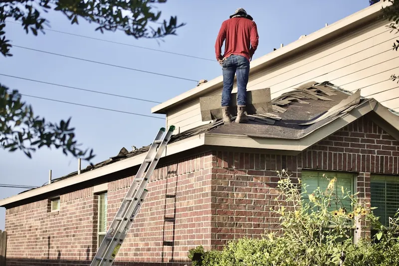 Professional roofer working on a residential roof in Airmont